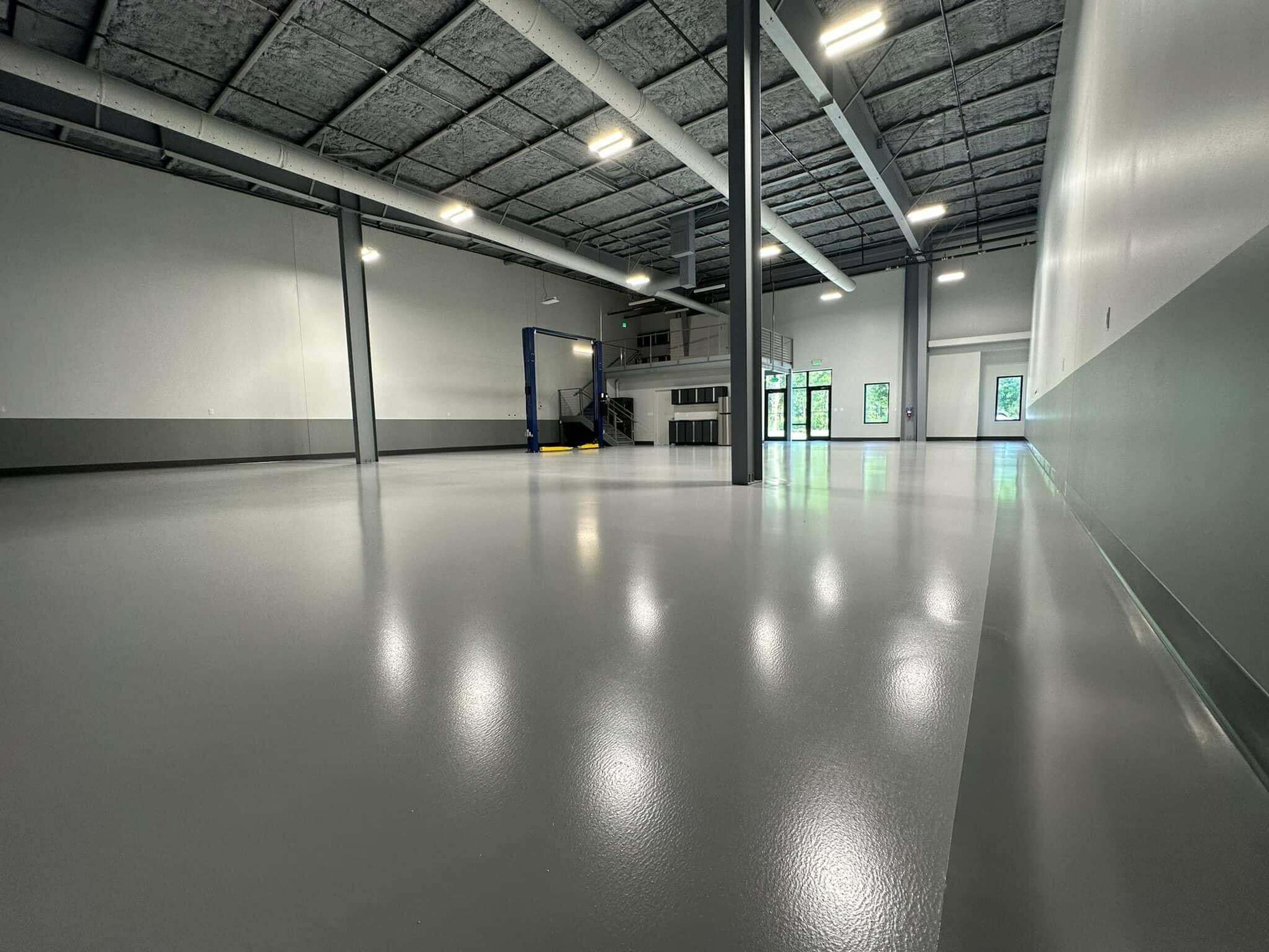Glossy gray epoxy floor in a commercial building corridor