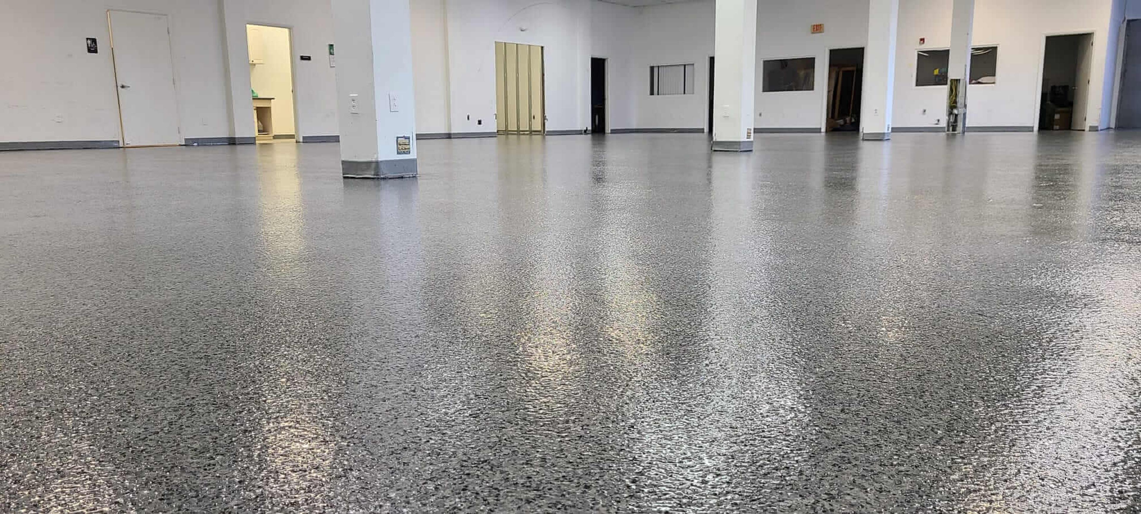 Speckled flake epoxy floor in an empty commercial space