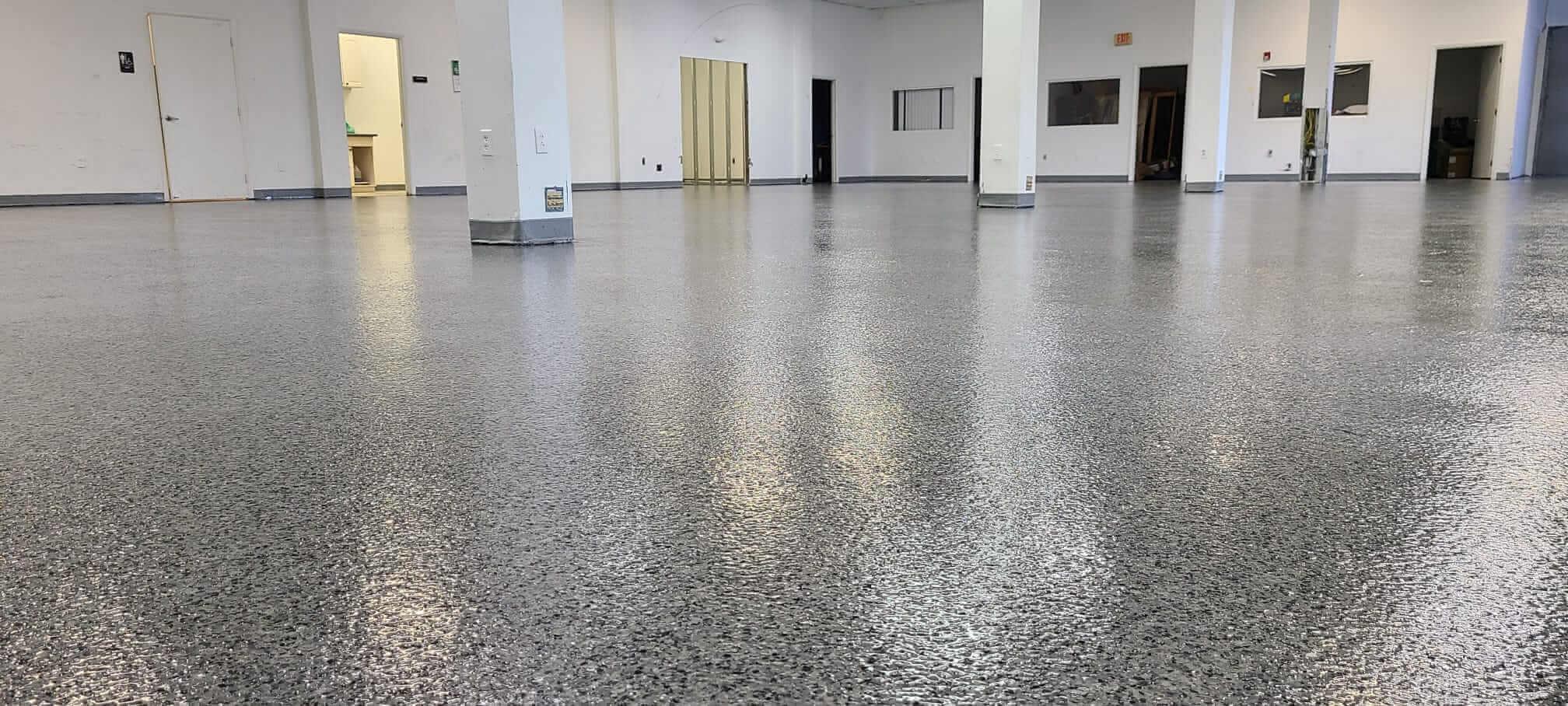 Speckled flake epoxy floor in an empty commercial space