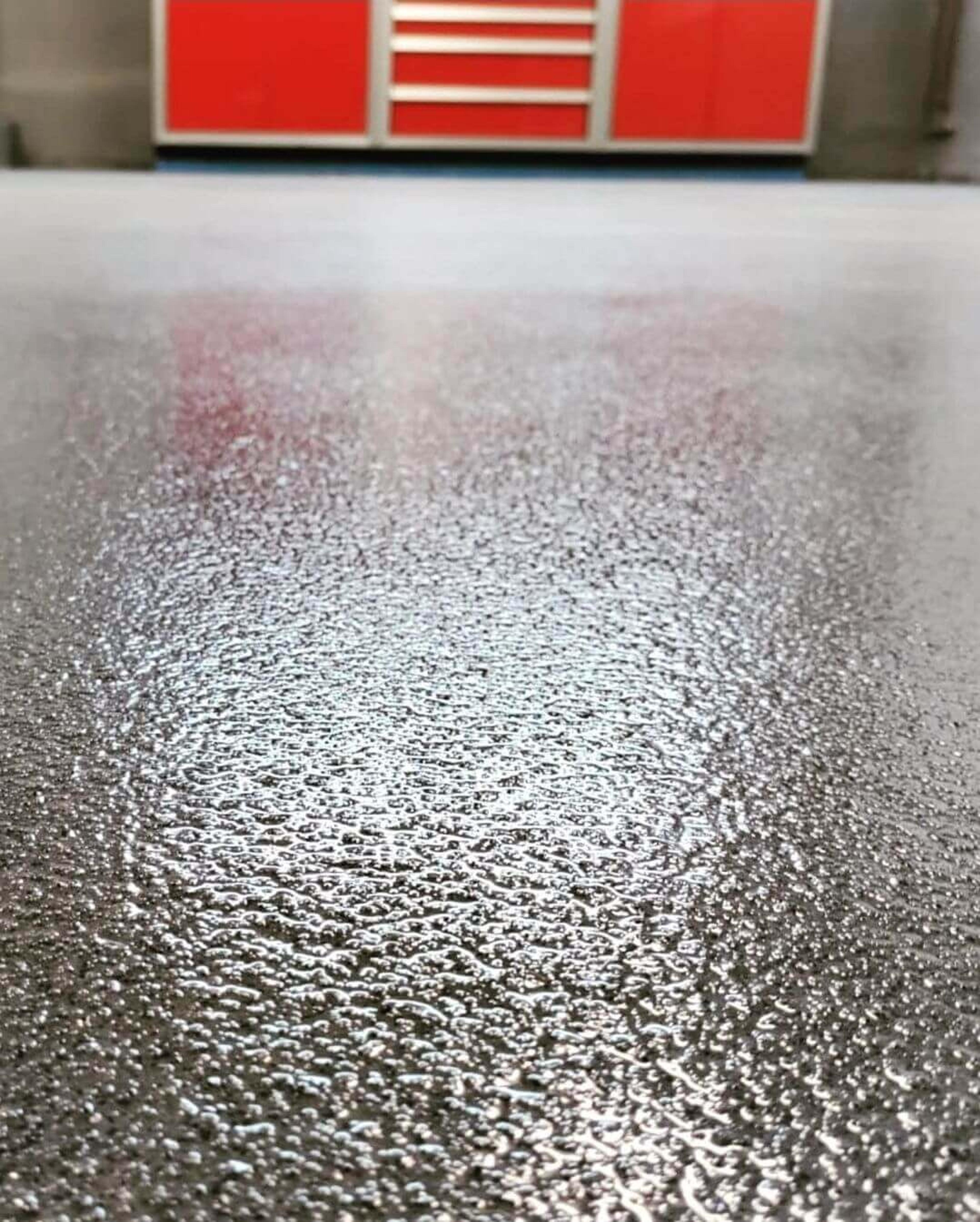 Close-up of a glossy gray flake epoxy floor
