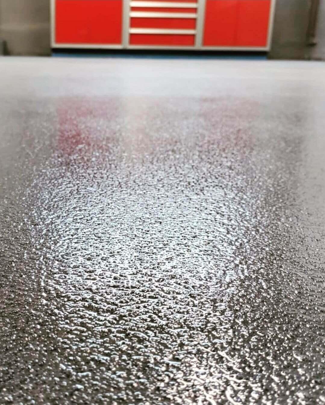 Close-up of a glossy gray flake epoxy floor