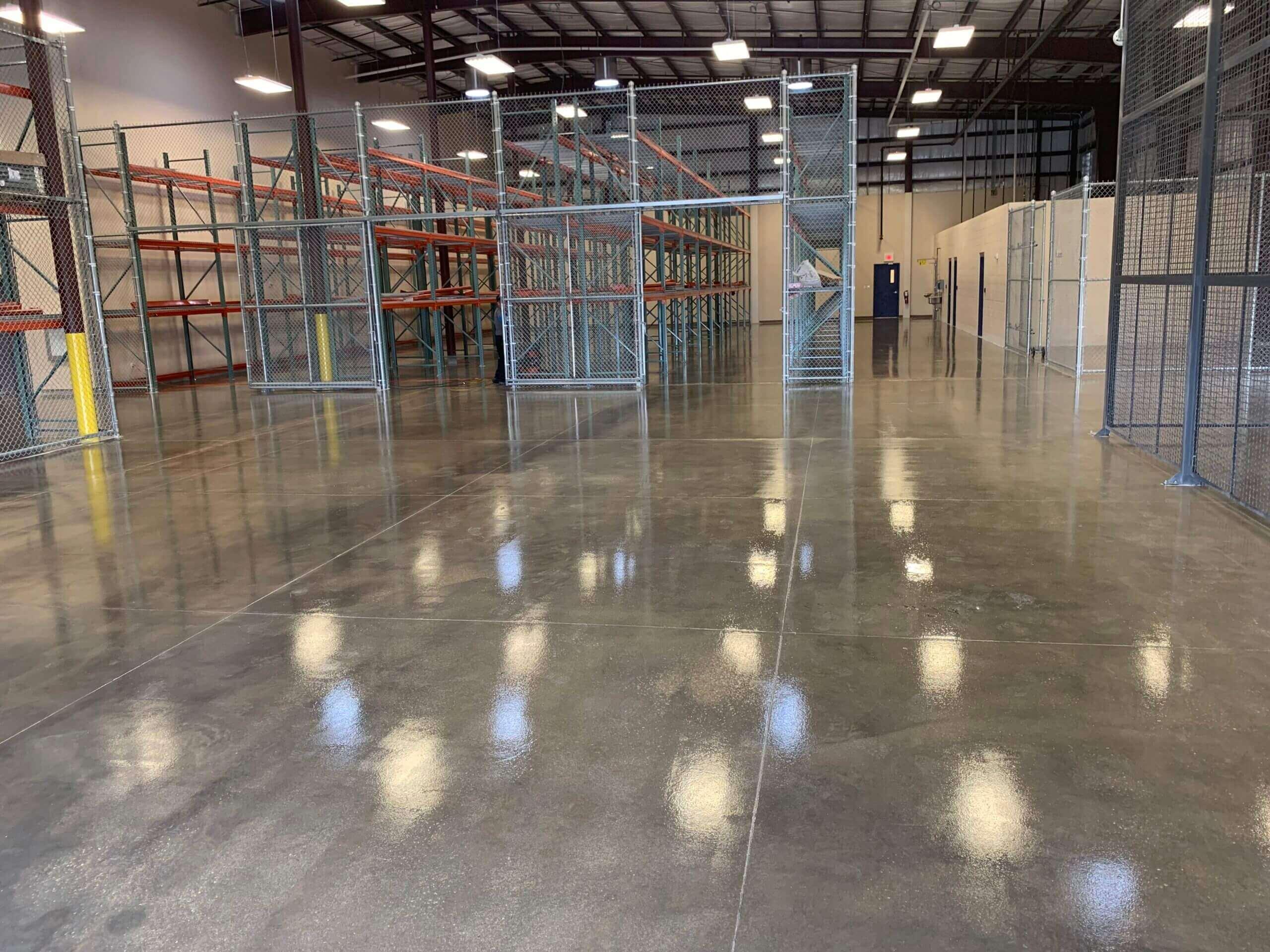 Polished concrete floor in a storage warehouse with wire mesh cages