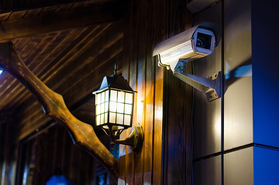 A security camera mounted on a wall, monitoring the surroundings for enhanced safety and surveillance.