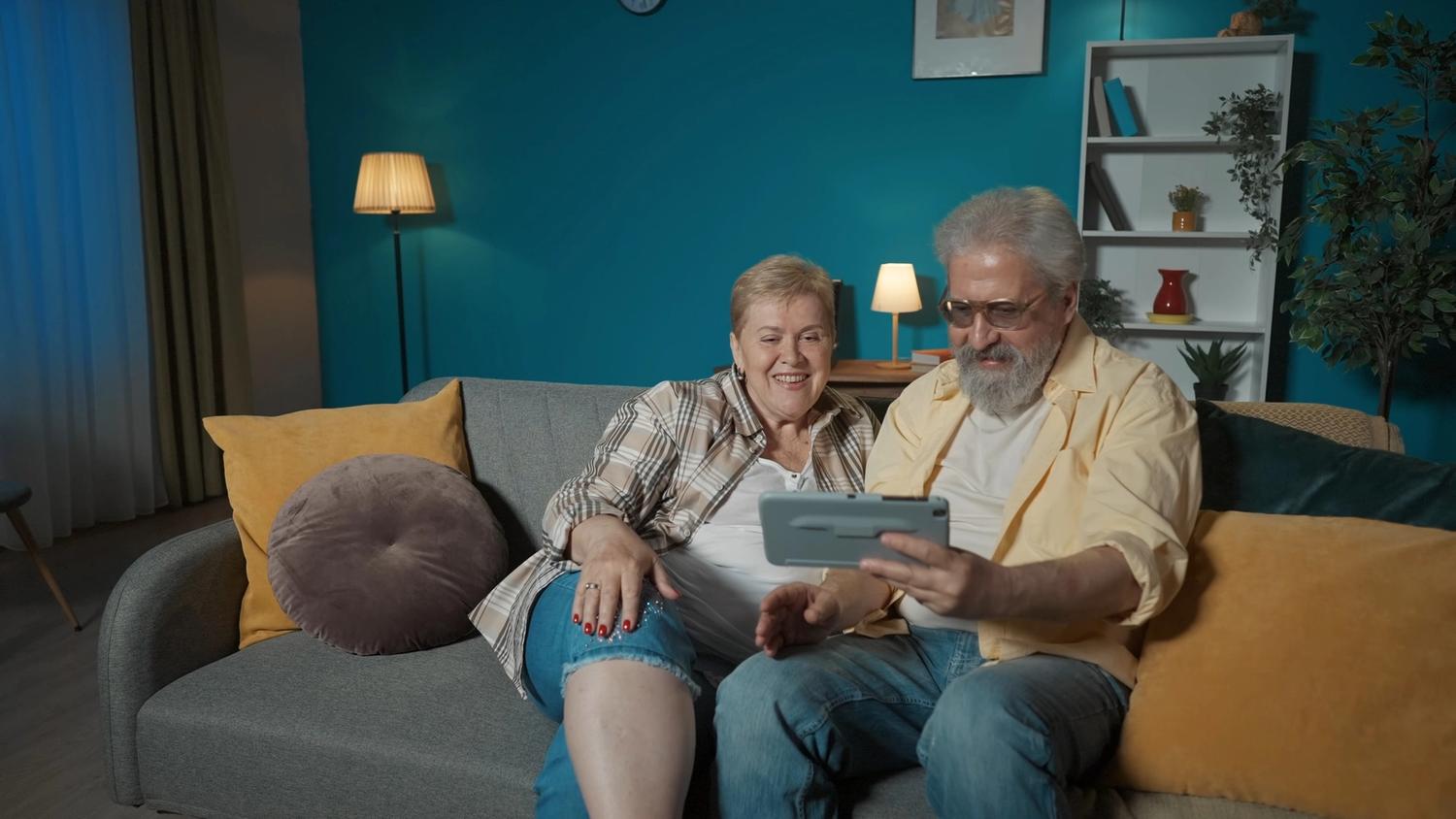 older couple on couch with ipad