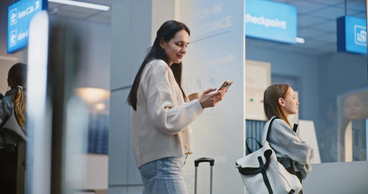 Woman in airport checking her security app