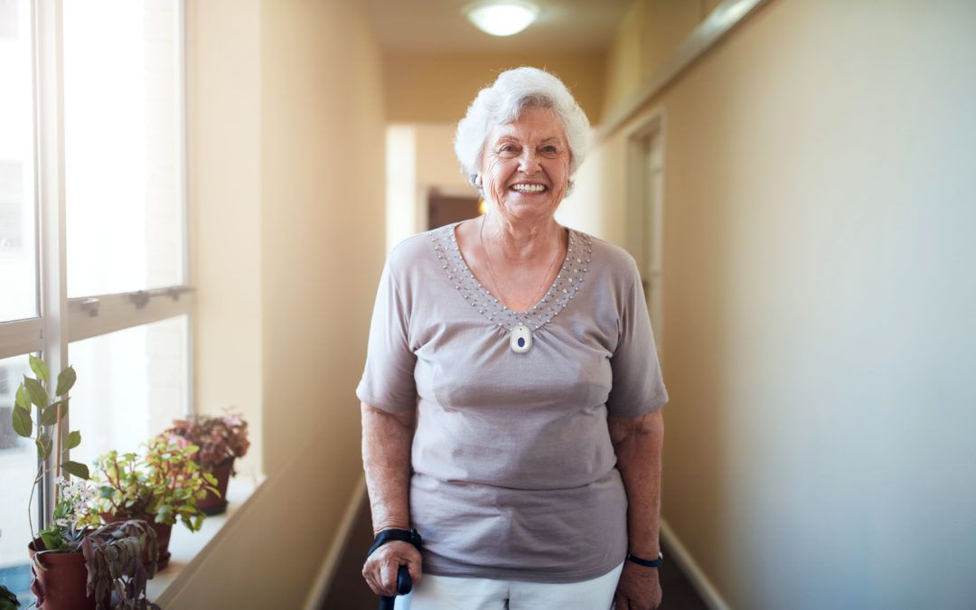 Elderly lady in a hallway smiling
