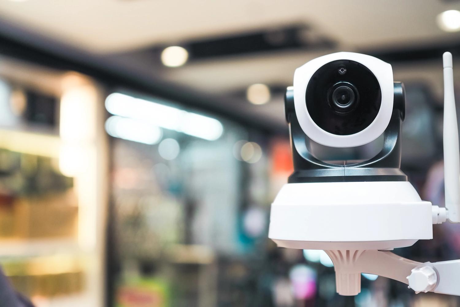 white and black coloured camera with a blurred background of a mall