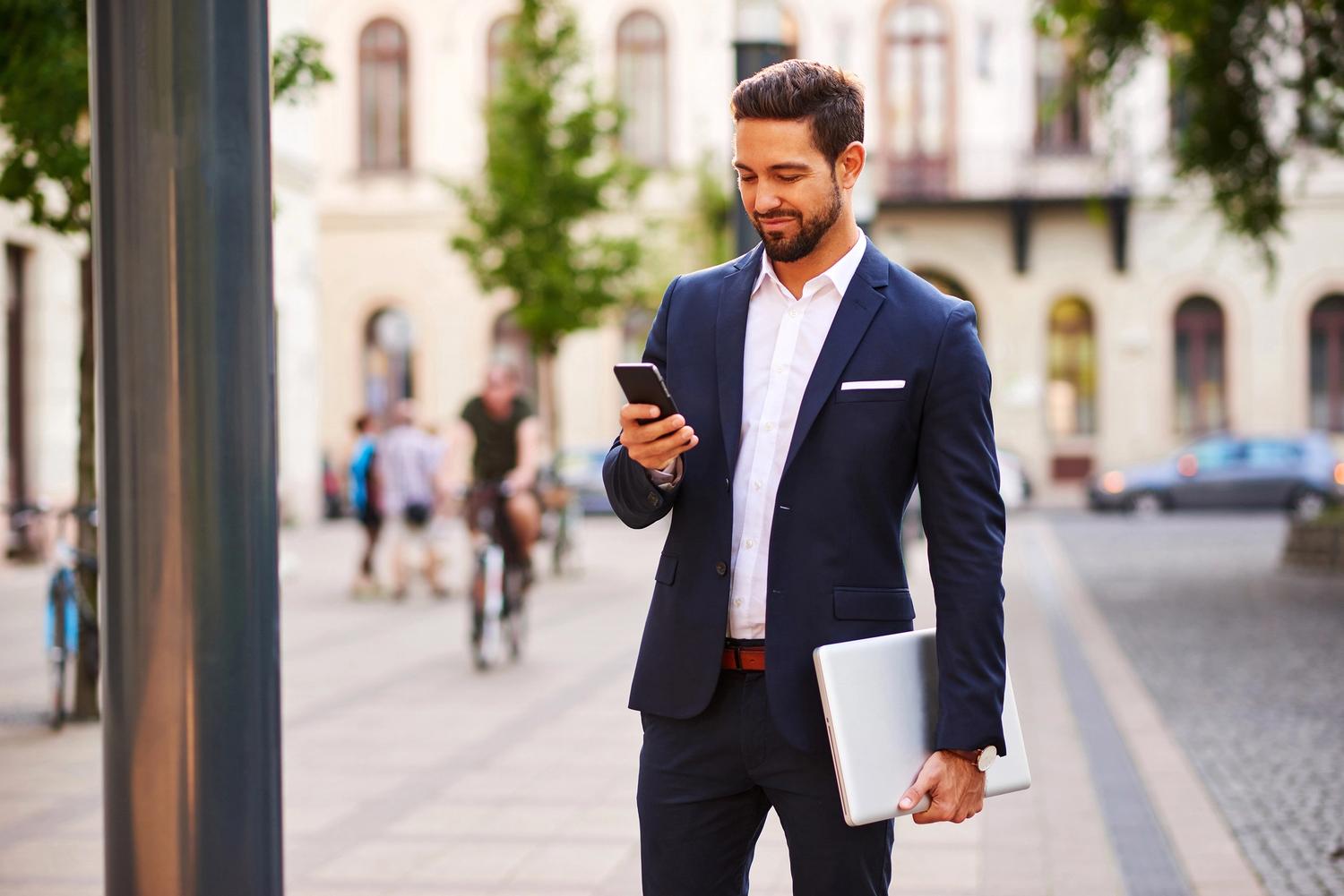 Man in a suit looking at his phone