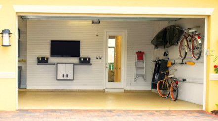 Open garage with visible items such as tv and bicycles