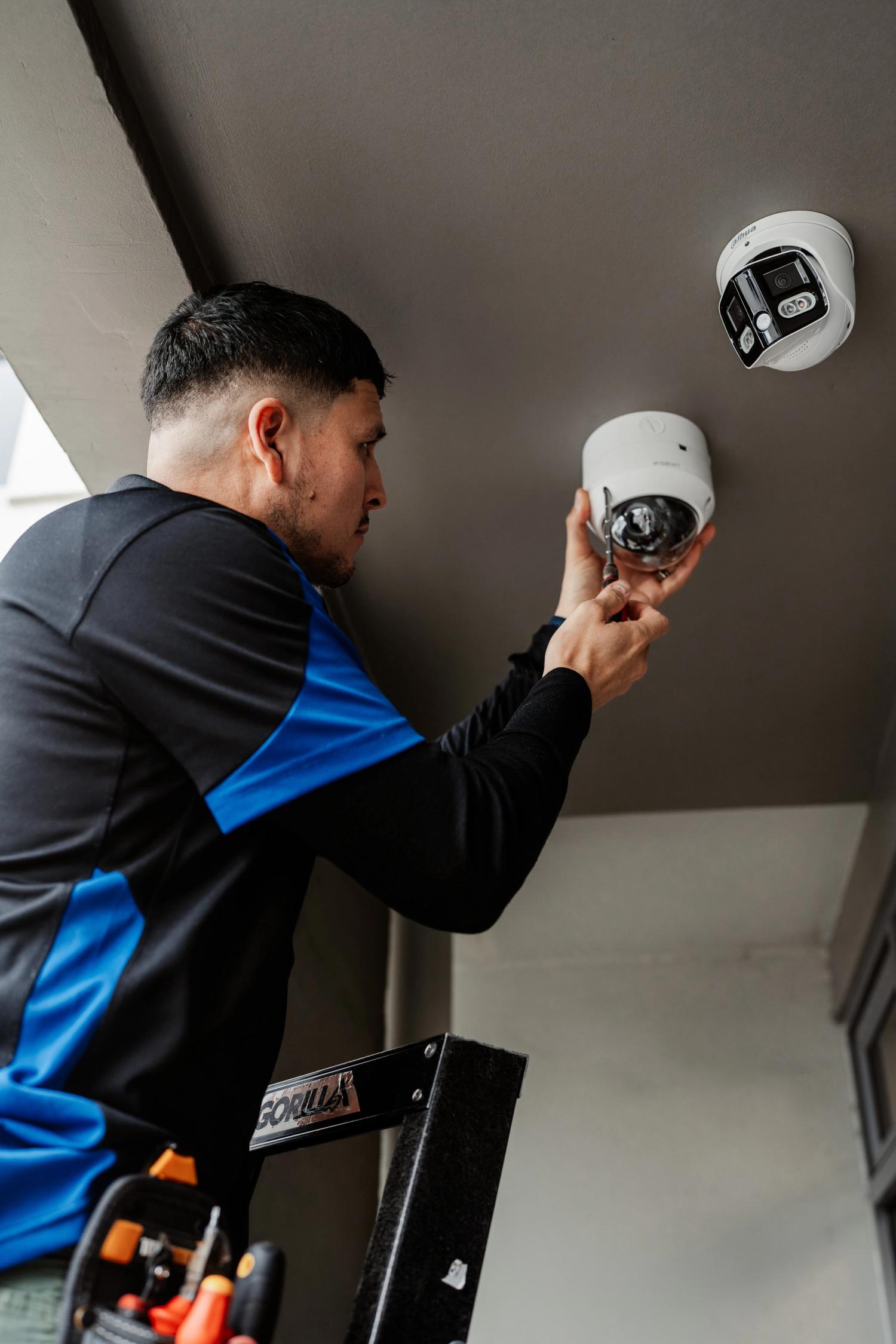 ADT technician working on camera