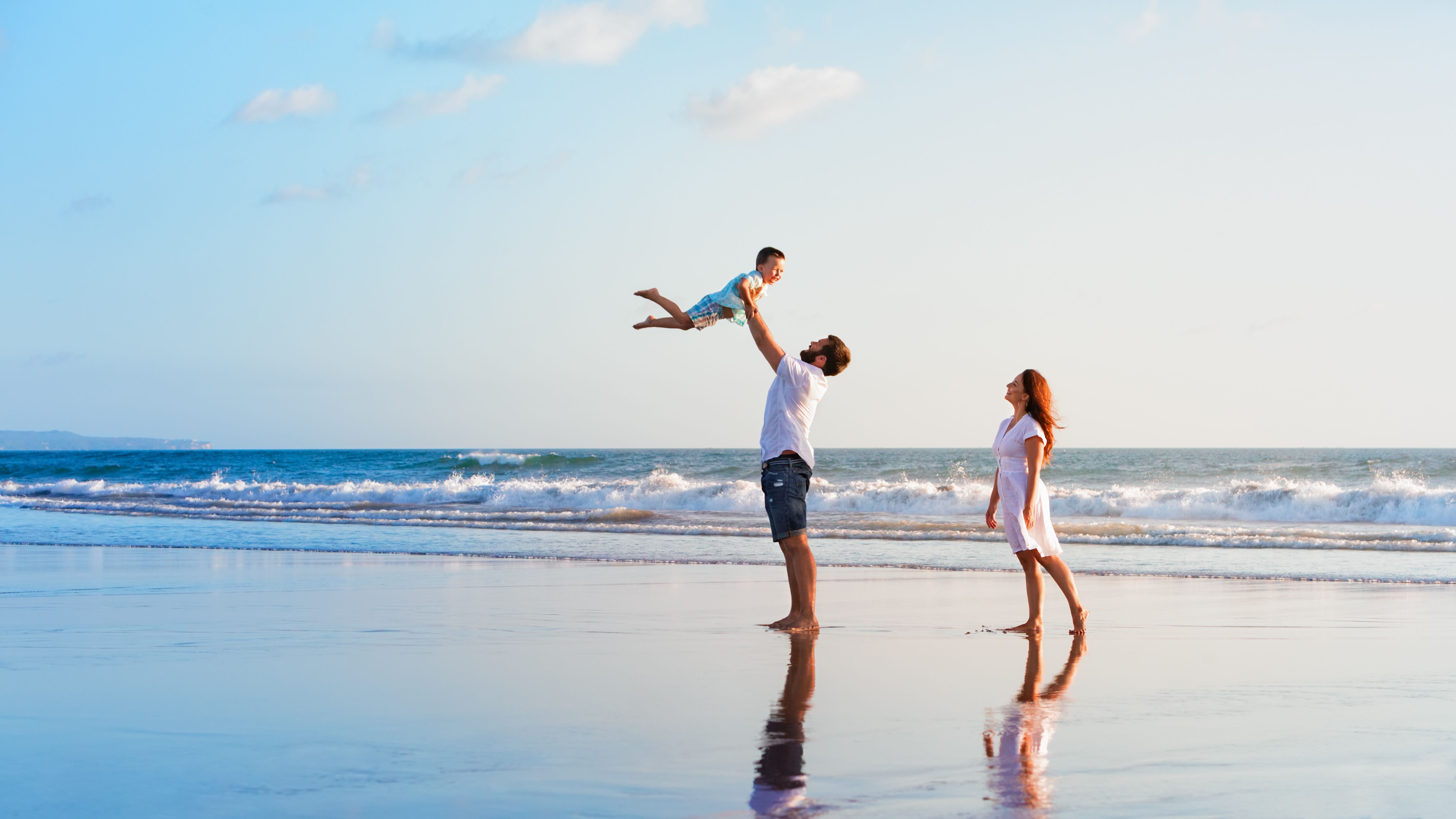 Parents and toddler playing on a beach