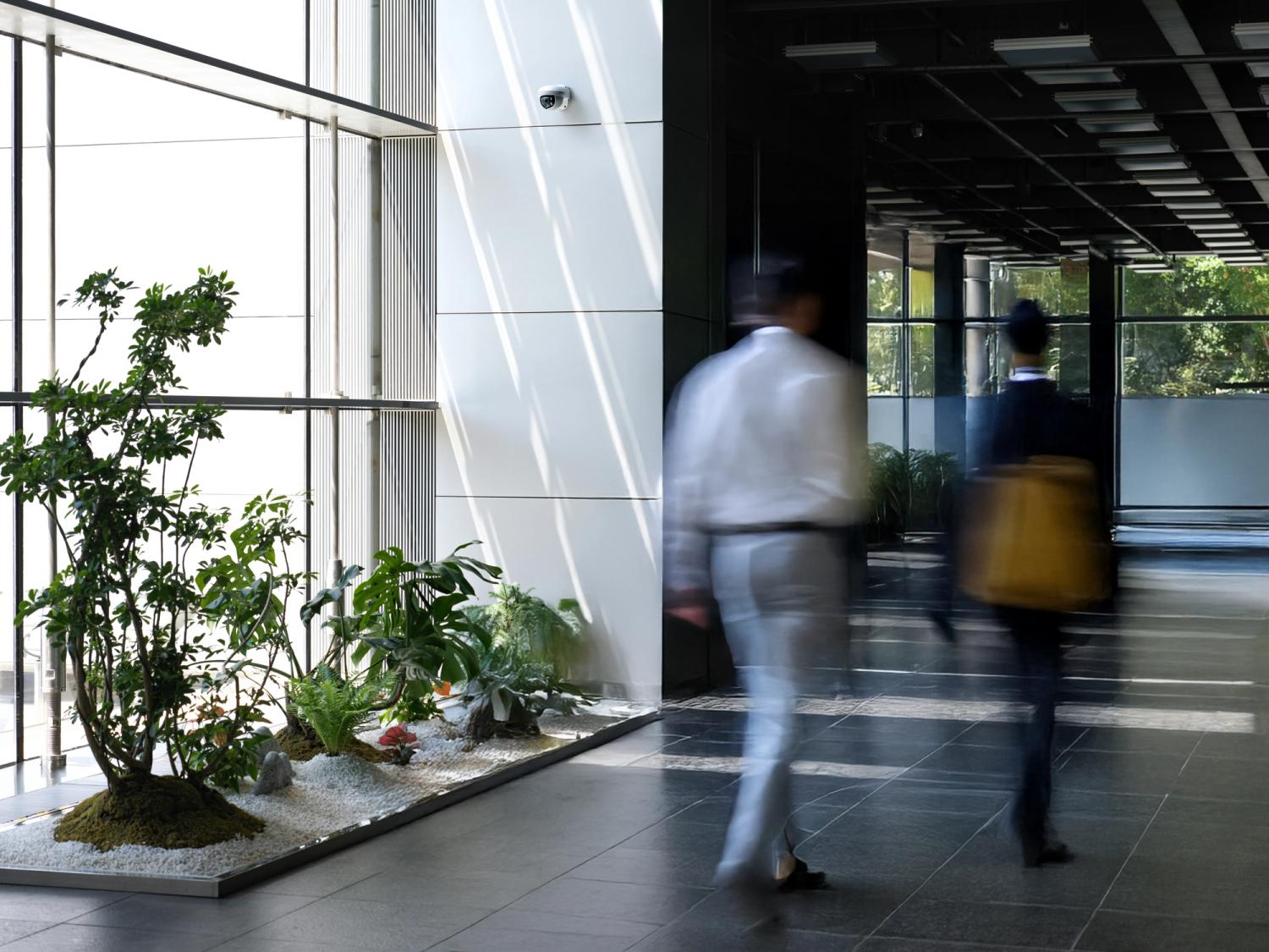 People walking through office foyer