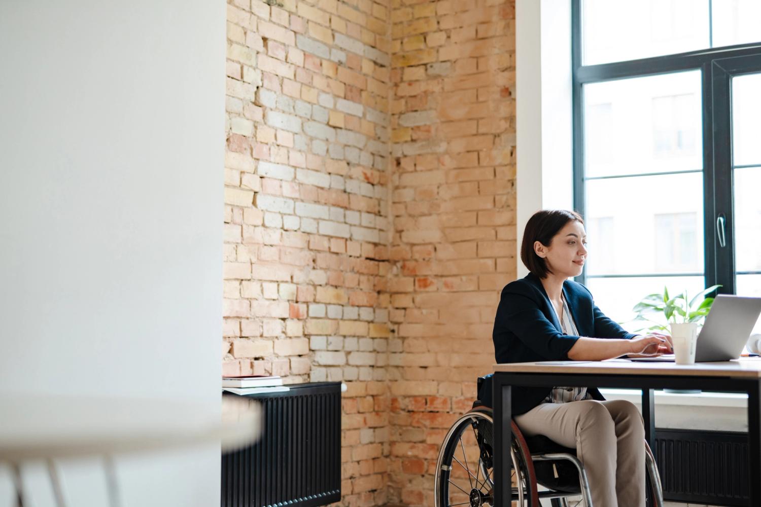 woman in wheelchair using laptop