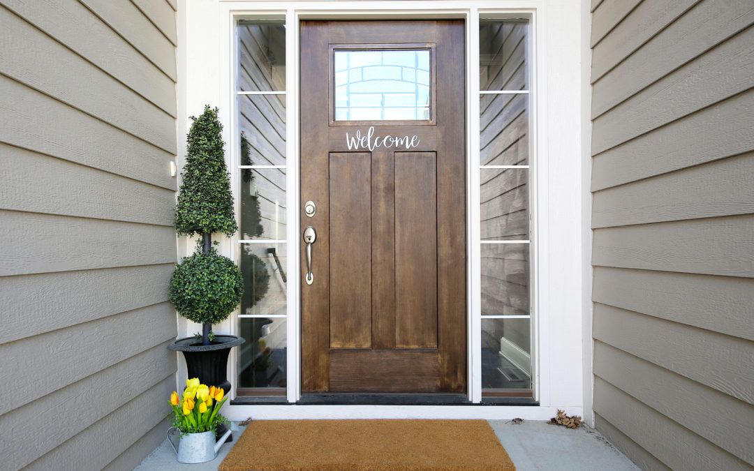 Front door that has the word 'Welcome' on it
