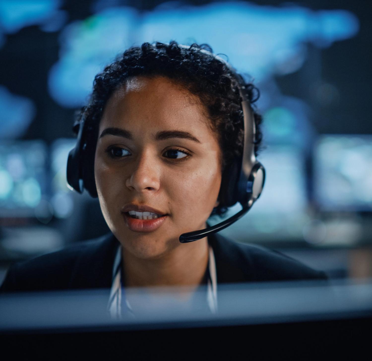 Female business security monitoring expert with headset