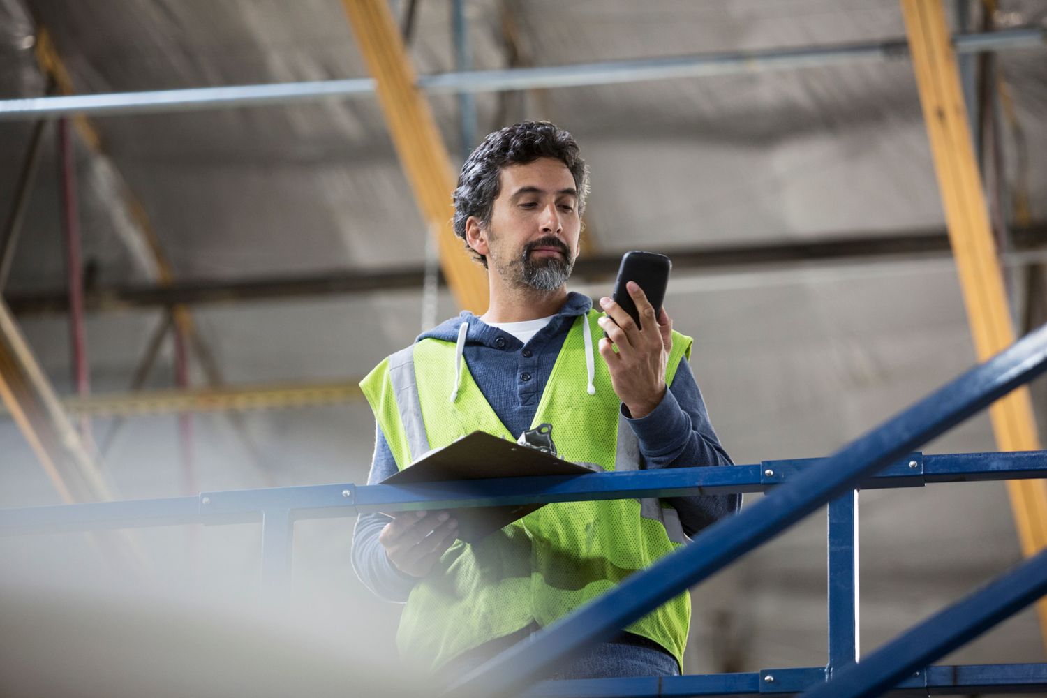 Worker in high vis looking at phone
