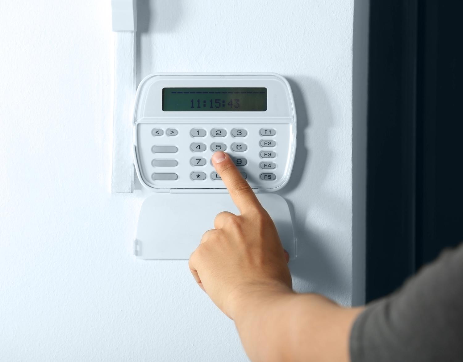 person putting in their alarm code