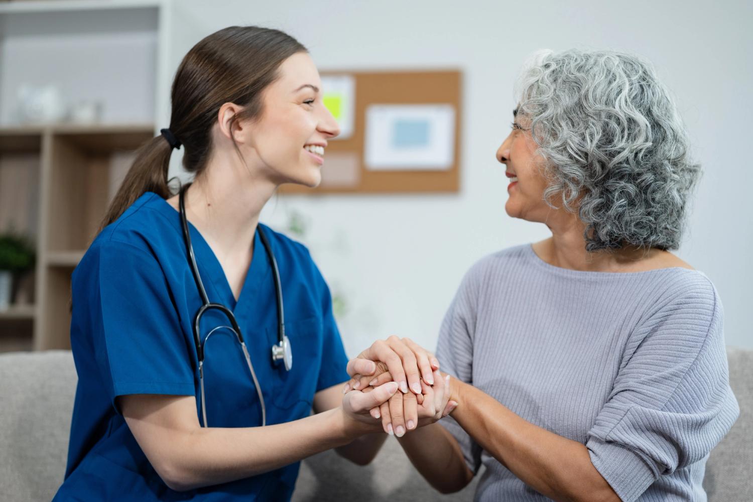 Carer holding woman's hand