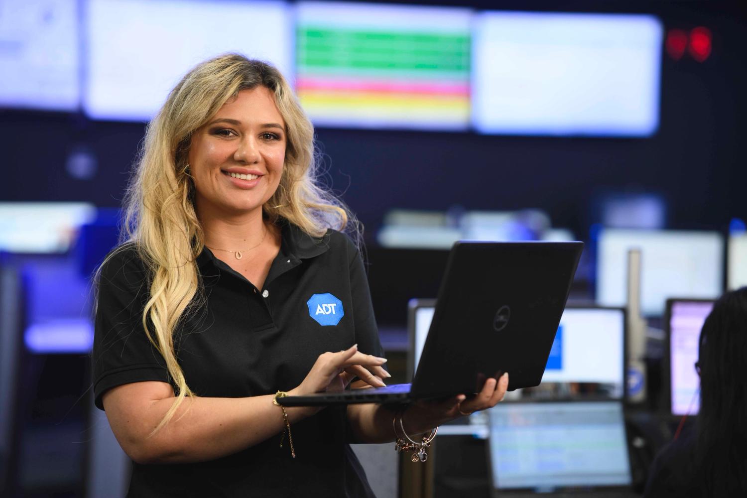woman smiling at phone at desk in warehouse