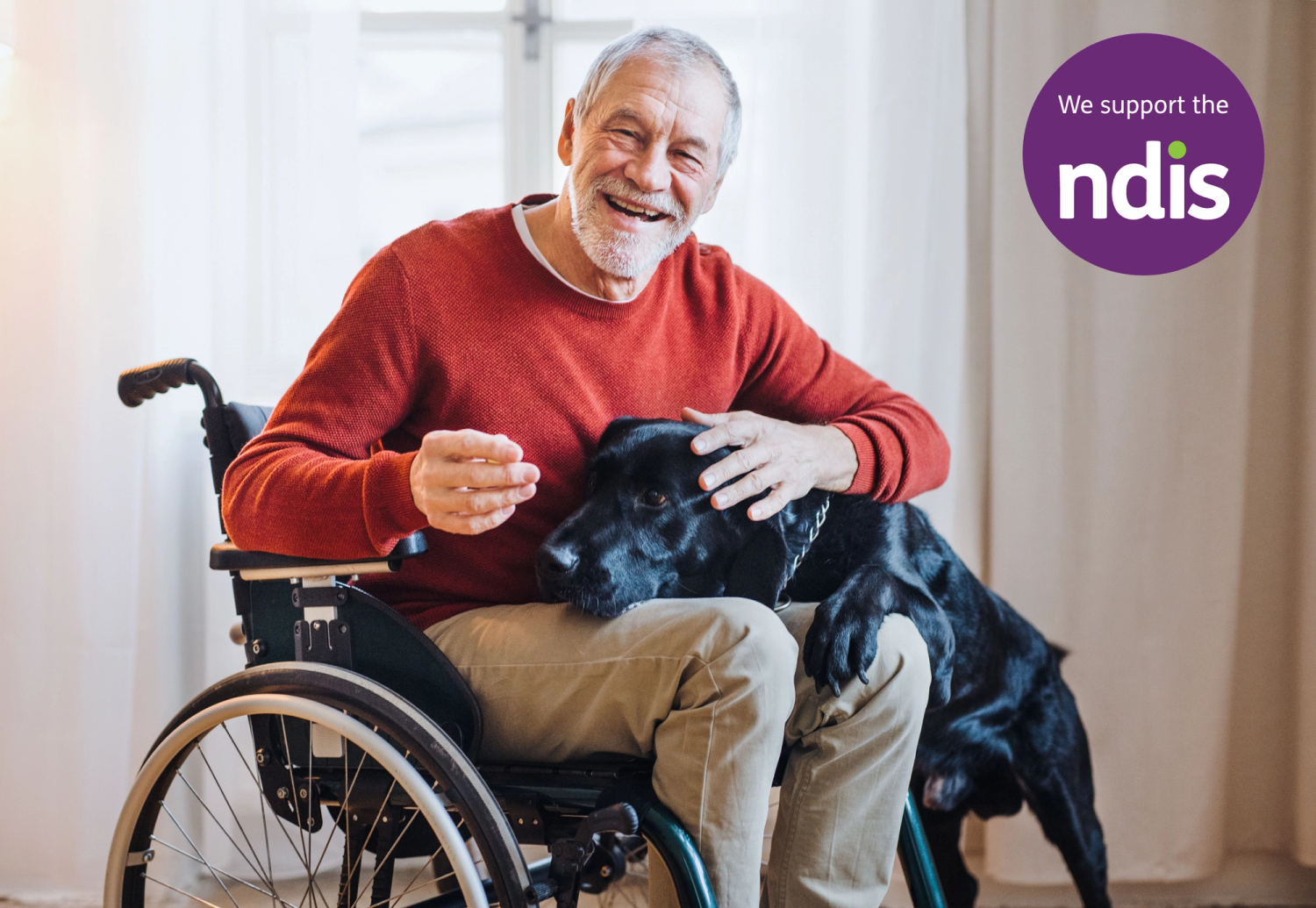 Man in wheelchair with dog and NDIS logo