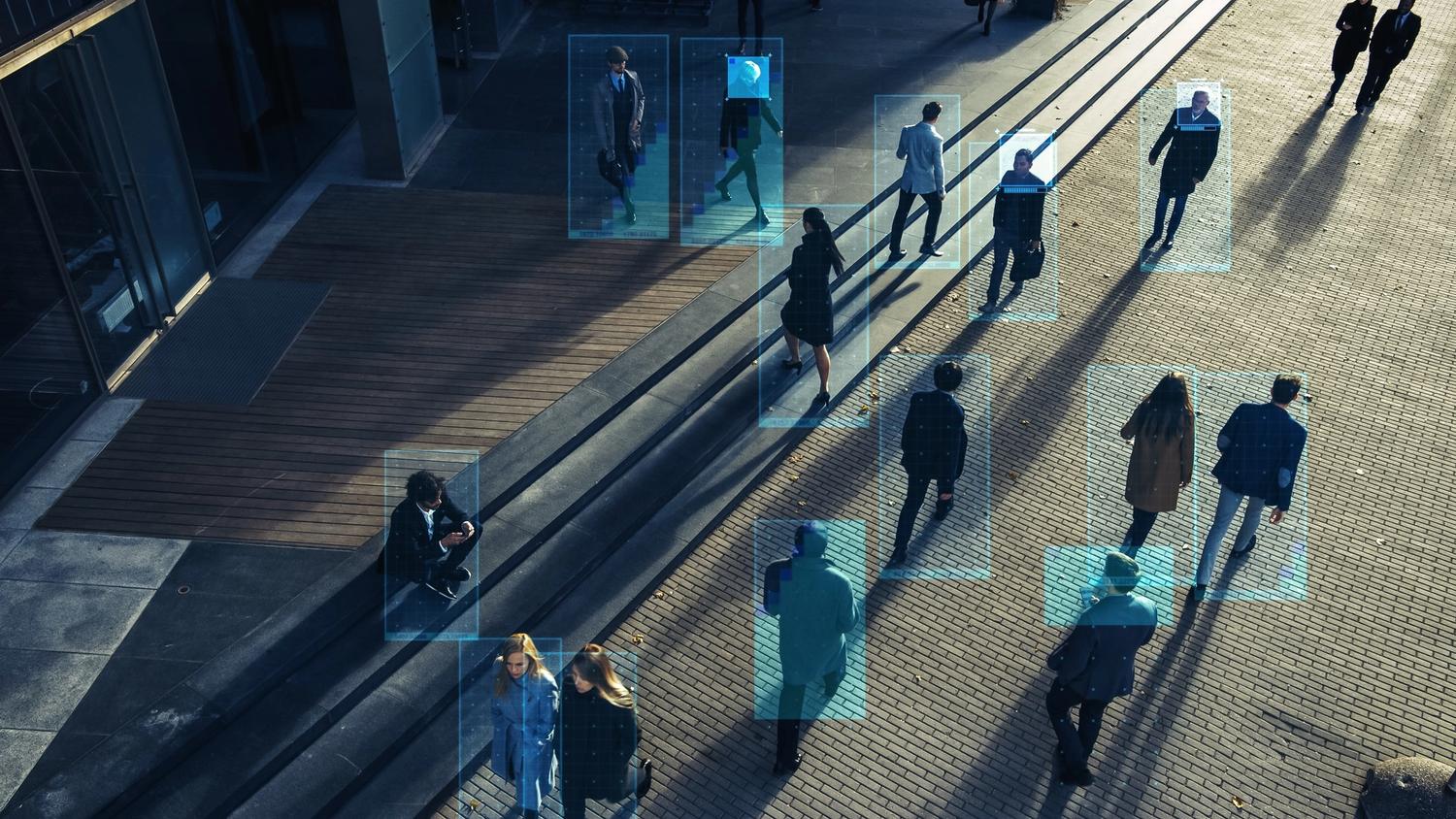 Man with headset checking business video monitoring cameras on screens.