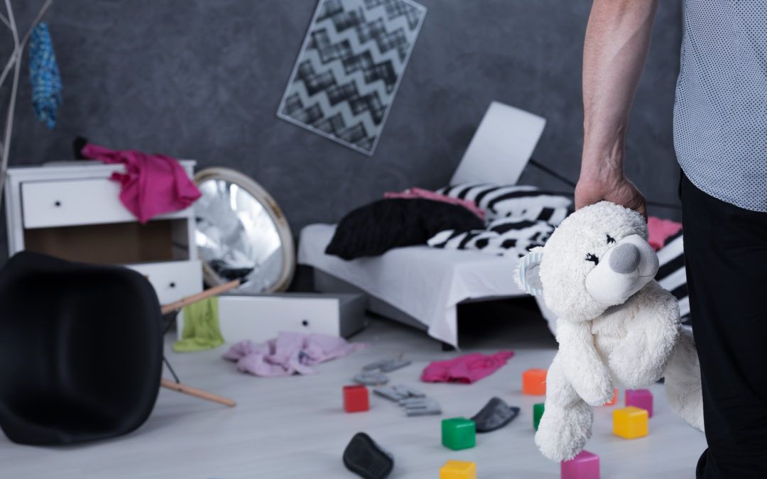 A trashed room with someone stealing a teddy bear
