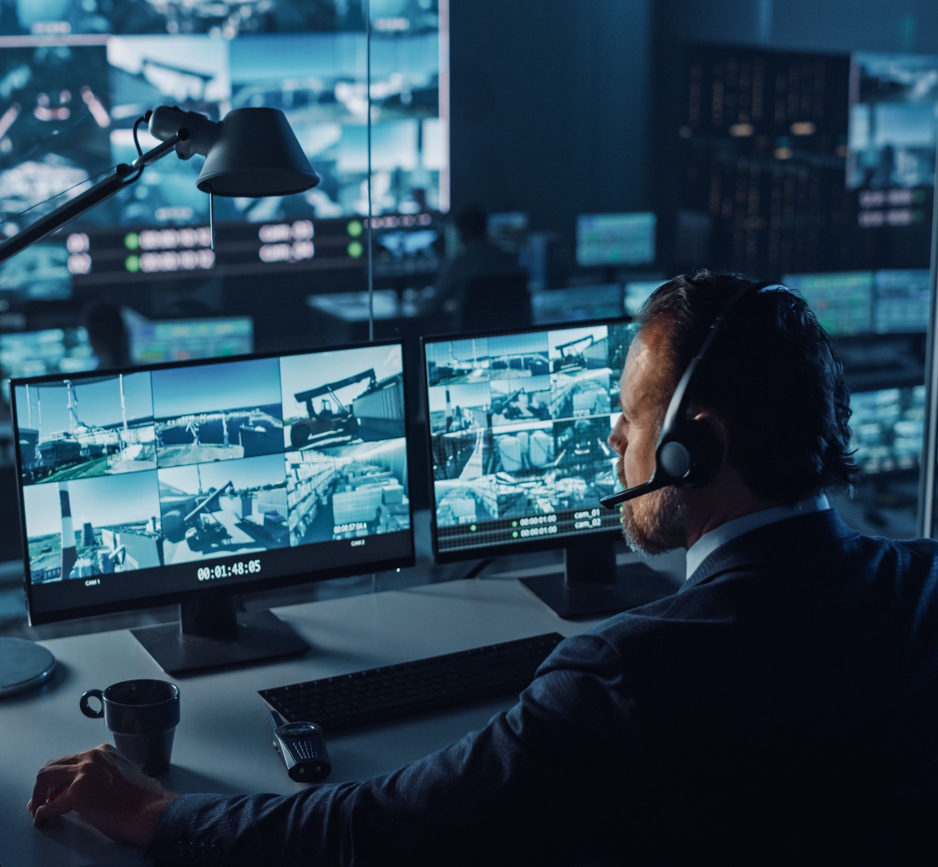 Security expert monitoring the premises via video monitoring cameras.