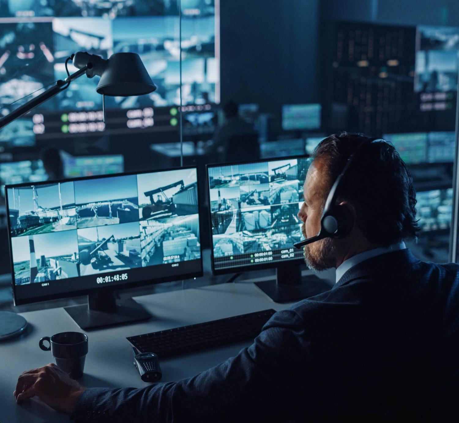 Security expert monitoring the premises via video monitoring cameras.