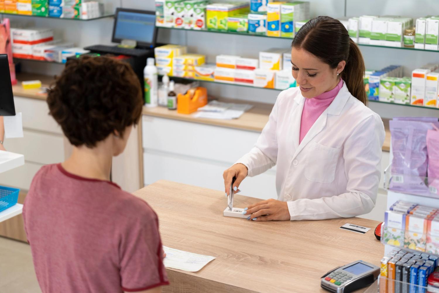 Female pharmacist serving a customer at the reception