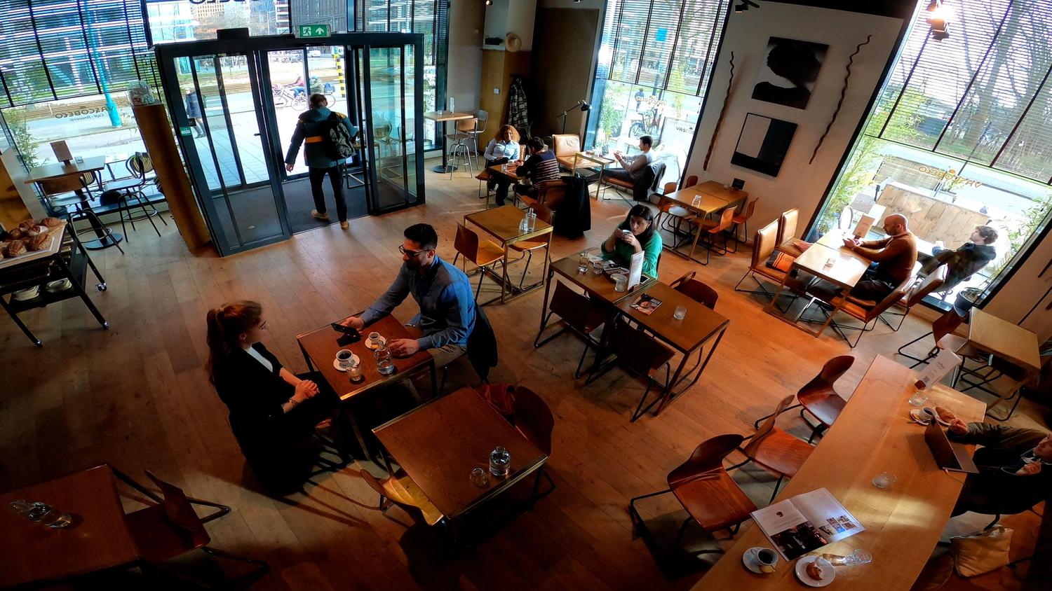 An downward view (likely from a camera) of a restaurant with people sitting
