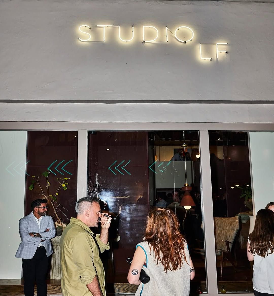 Guests outside the Studio LF showroom under its neon sign