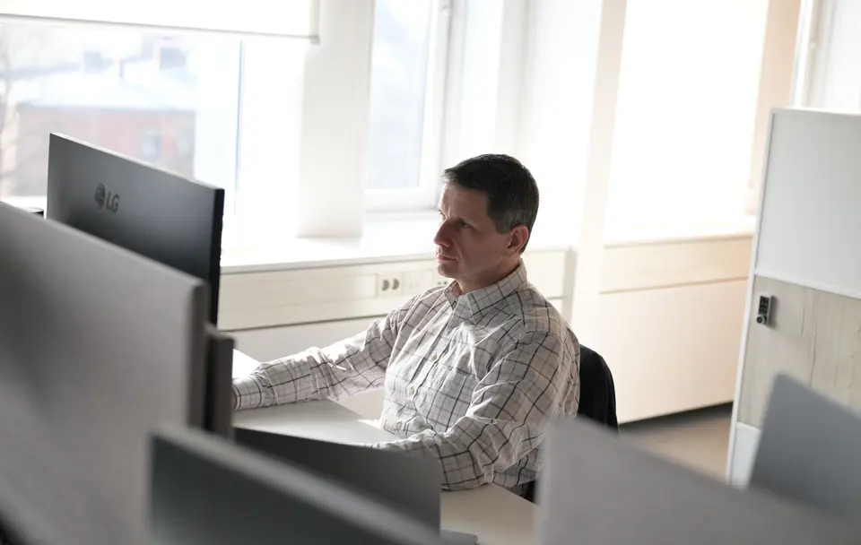 Man sitting in front of laptop working.