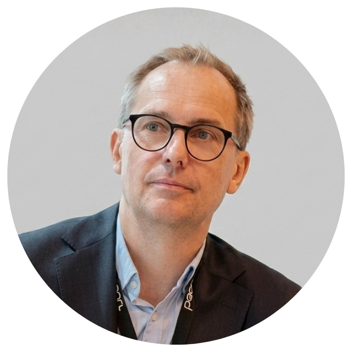 Male in glasses and black jacket and airpod in his ear.