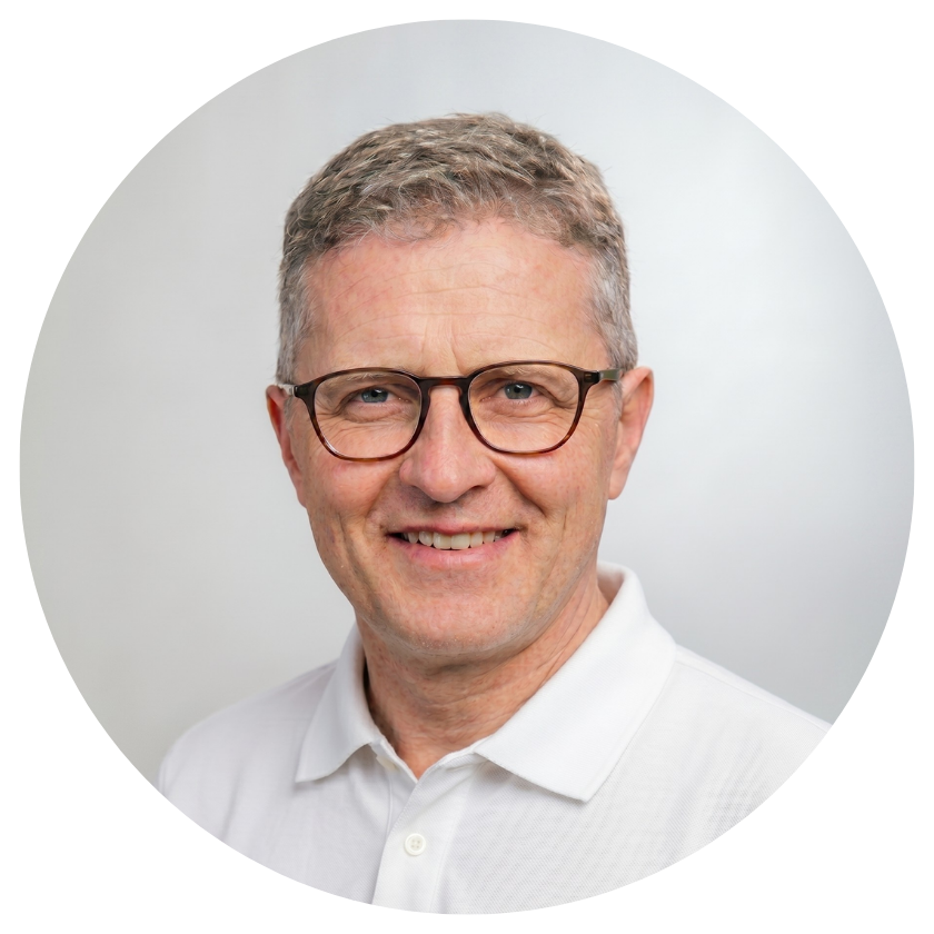 Smiling man with glasses in a white shirt photographed against a light grey background in a circular crop portrait photo.