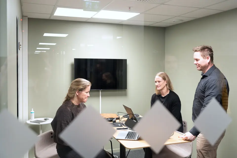 Three people in a room.