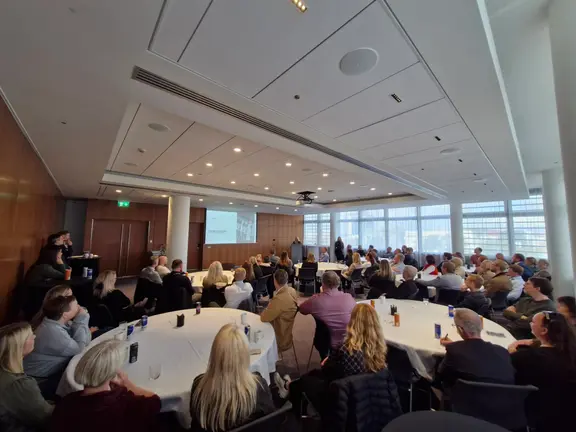 Many people in a meeting room.