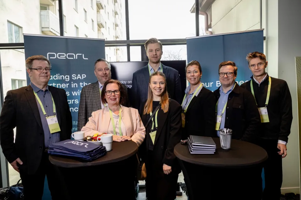 People standing in group at an event.