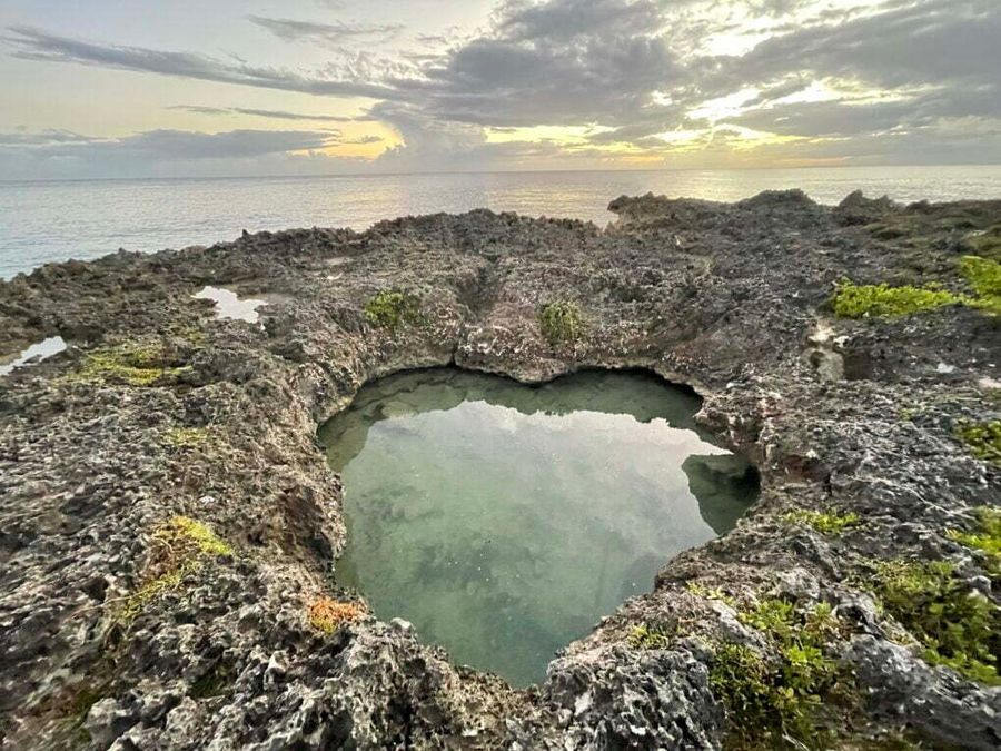 Průzračná voda v temné jeskyni Chico Cave, Dominikánská republika.