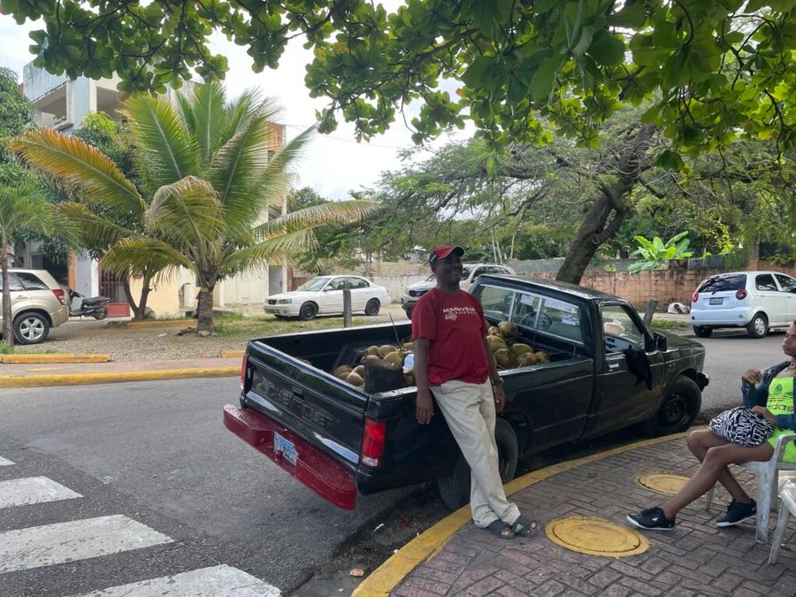 Prodejce kokosú v Puerto Plata, Dominikánská republika.