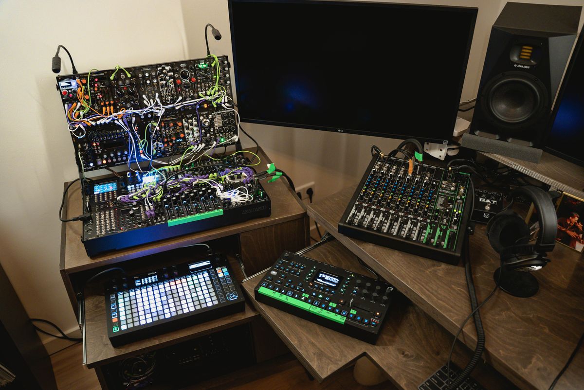 A complete modular synthesizer setup with a grid sequencer, mixer, headphones and studio monitor