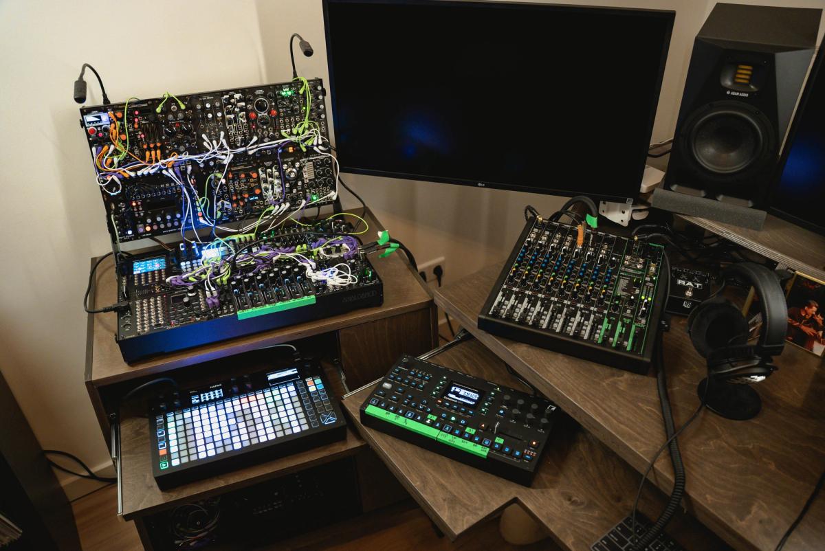 A complete modular synthesizer setup with a grid sequencer, mixer, headphones and studio monitor