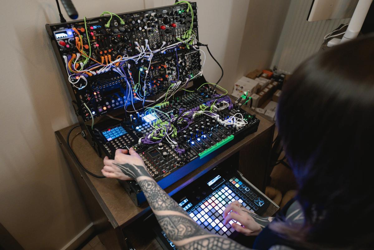Overhead view of Krista working at the modular case and illuminated grid sequencer