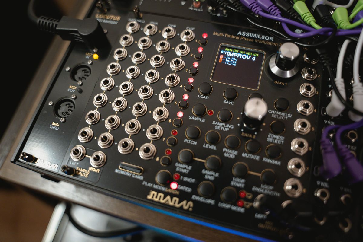 Close-up of an Assimil8or sampler module with its illuminated display and rows of patch sockets
