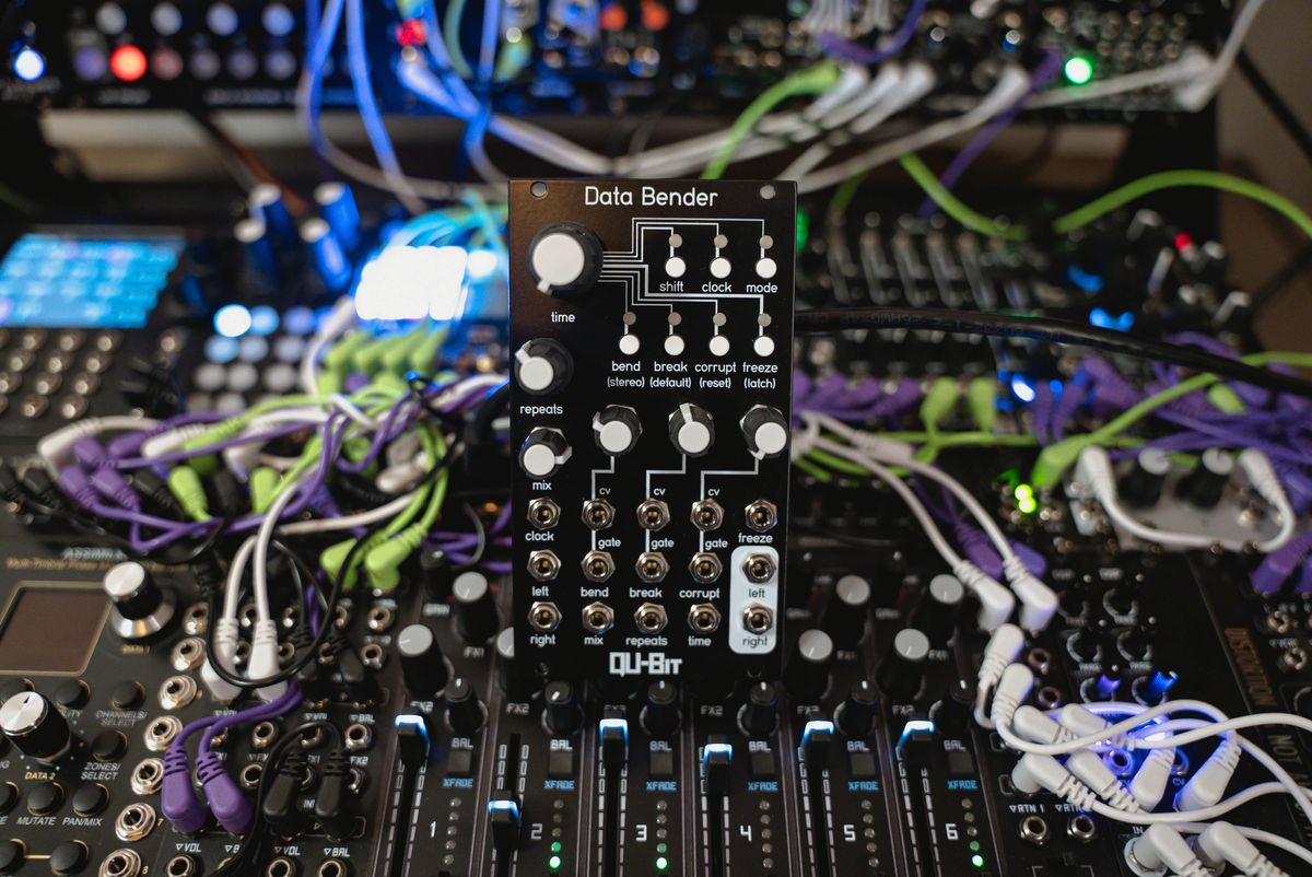 A Data Bender effects module held in front of the patched modular synthesizer
