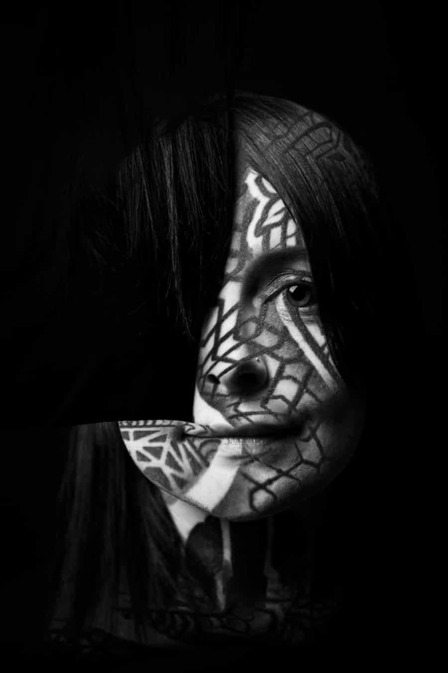 Black and white close-up of Krista with patterned light and shadow across her face