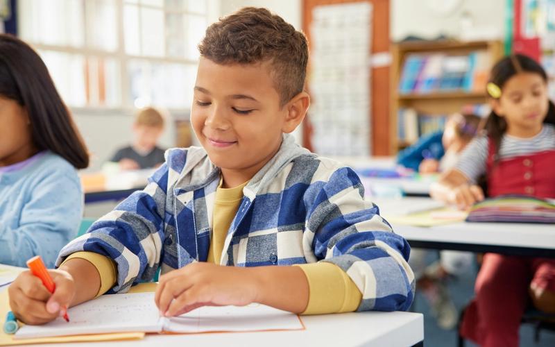 Student practicing reading and writing skills with support for dyslexia.