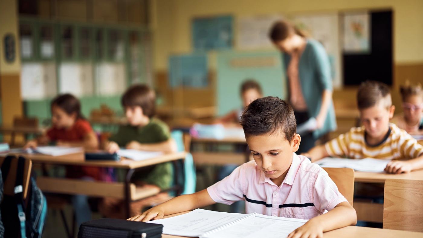 Student struggling to read in classroom showing challenges of dyslexia.