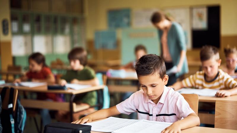 Student struggling to read in classroom showing challenges of dyslexia.