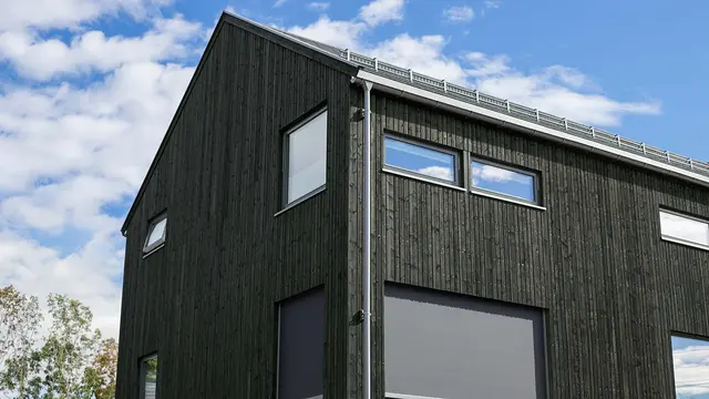 Hus med ny kledning i grønnfarge.