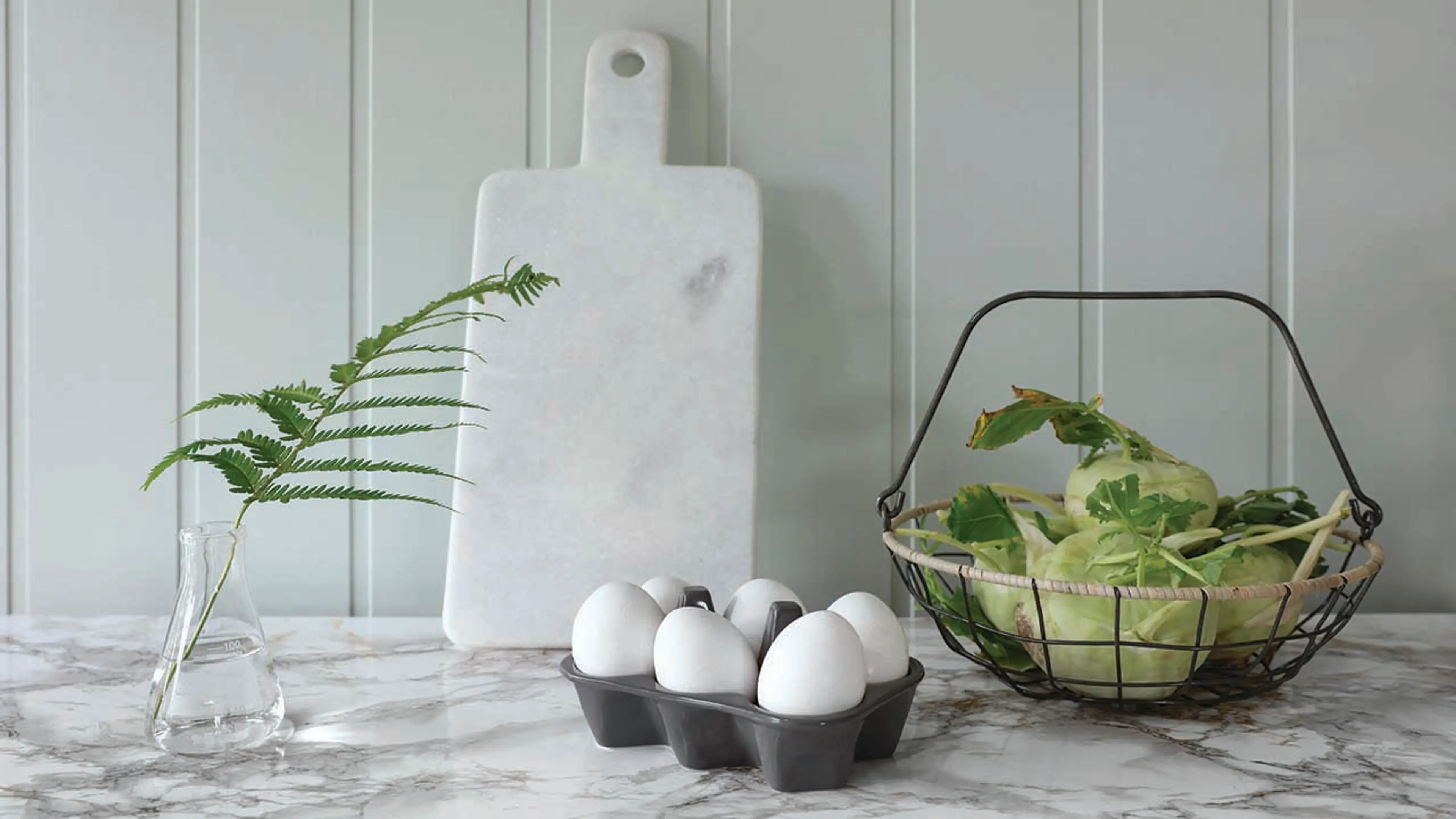 Huntonitt veggplater i Soft Menthol fra Byggma over kjøkkenbenk med benkeplate i stein.